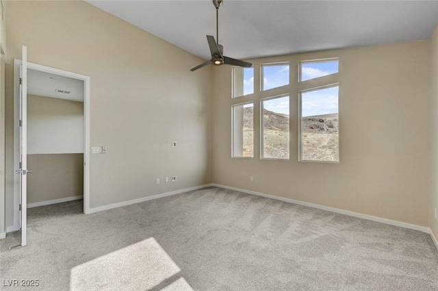 unfurnished bedroom with ceiling fan, light colored carpet, and vaulted ceiling