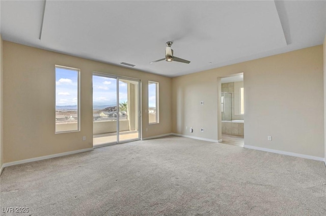 spare room featuring light colored carpet and ceiling fan