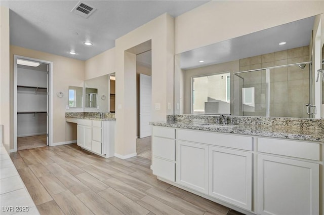 bathroom with vanity and walk in shower