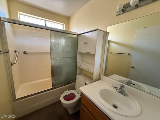 full bathroom featuring vanity, enclosed tub / shower combo, and toilet