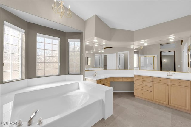 bathroom with vanity, plenty of natural light, and lofted ceiling