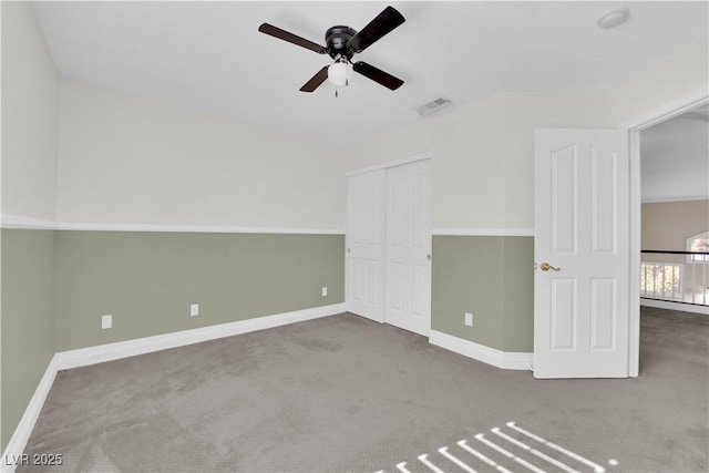 carpeted empty room with ceiling fan