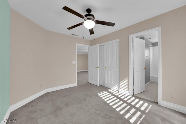 unfurnished bedroom with light carpet, ceiling fan, and a closet