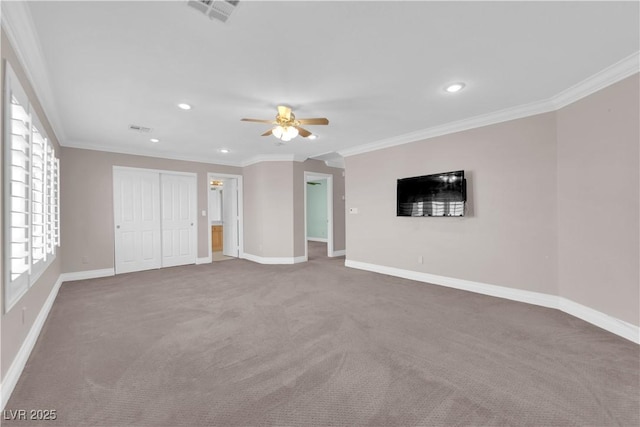 unfurnished bedroom featuring carpet flooring, ornamental molding, ceiling fan, ensuite bath, and a closet