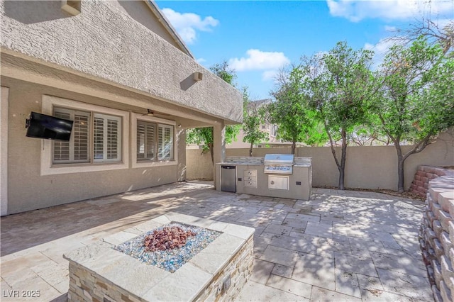 view of patio featuring area for grilling, an outdoor fire pit, and grilling area