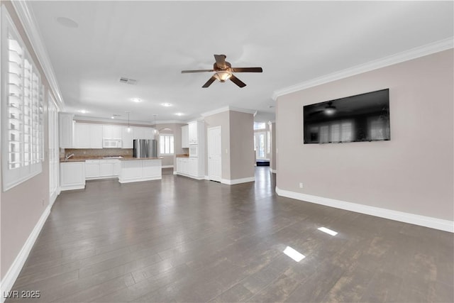 unfurnished living room featuring dark wood-type flooring, ceiling fan, and ornamental molding