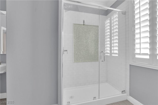 bathroom featuring a shower with shower door