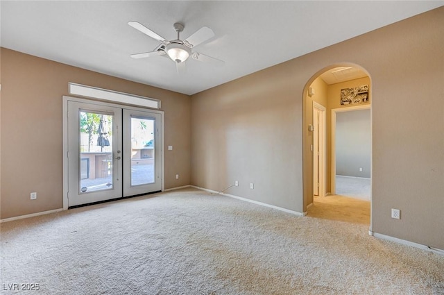 unfurnished room featuring light colored carpet, ceiling fan, and french doors