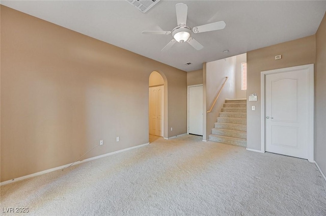 unfurnished living room with light colored carpet and ceiling fan