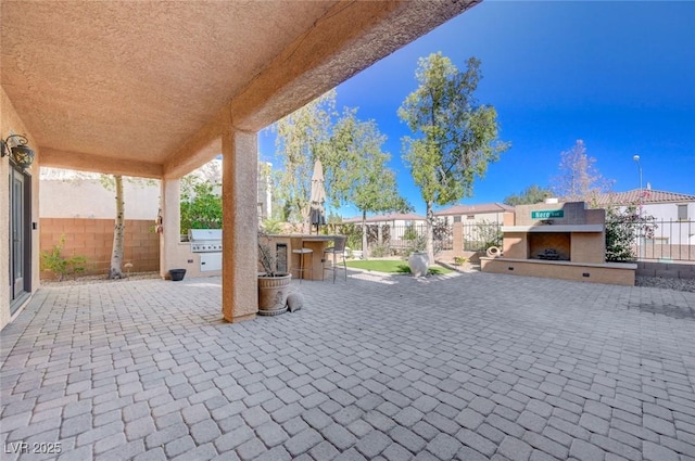 view of patio featuring exterior kitchen and an outdoor bar