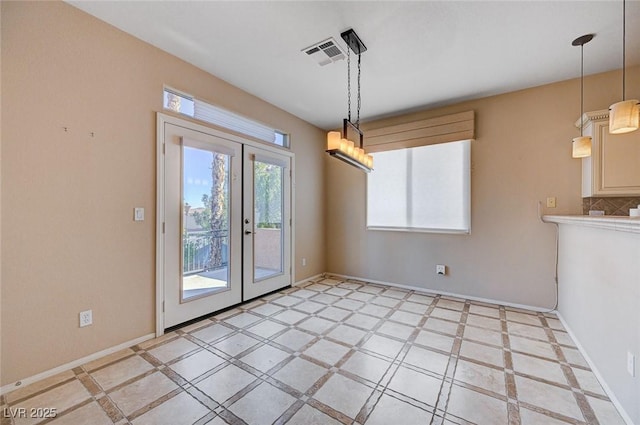 unfurnished dining area with french doors