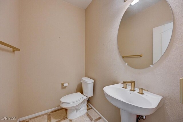 bathroom featuring sink and toilet