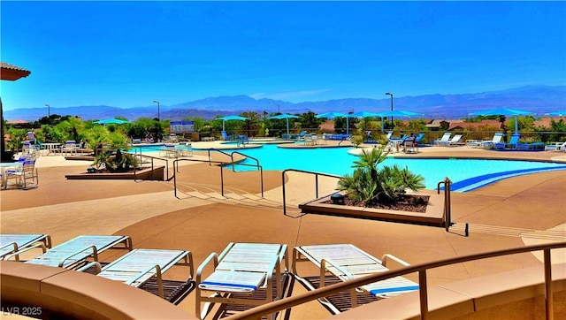 view of pool featuring a mountain view and a patio area