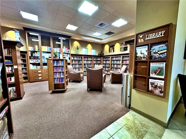 home office featuring carpet and a drop ceiling