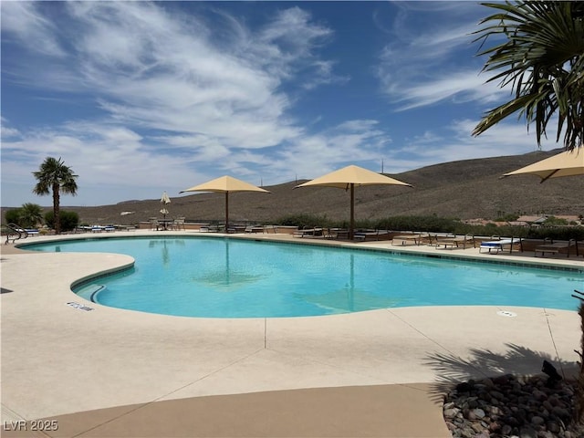 view of swimming pool featuring a mountain view