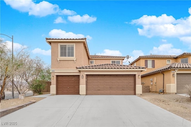 mediterranean / spanish-style home with a garage