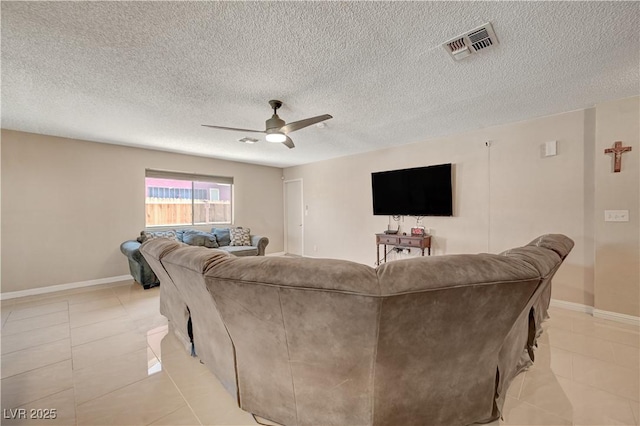 tiled living room with a textured ceiling and ceiling fan