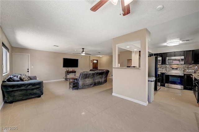 tiled living room with a textured ceiling and ceiling fan