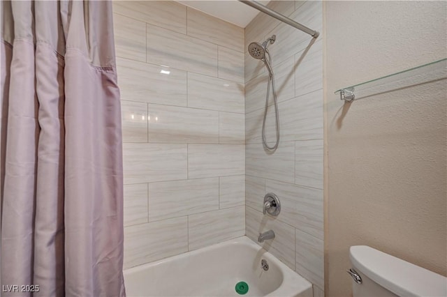 bathroom featuring shower / bathtub combination with curtain and toilet