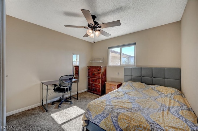 bedroom with ceiling fan, carpet flooring, and a textured ceiling