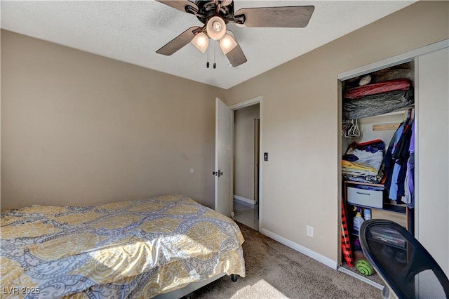 carpeted bedroom with ceiling fan and a closet