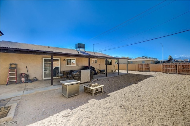 rear view of property with cooling unit and a patio area