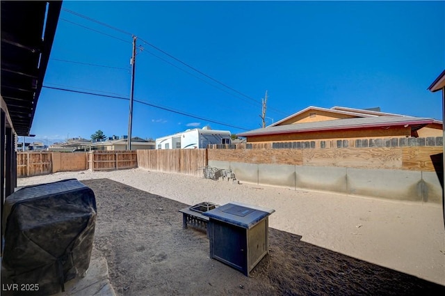 exterior space with grilling area and a fire pit