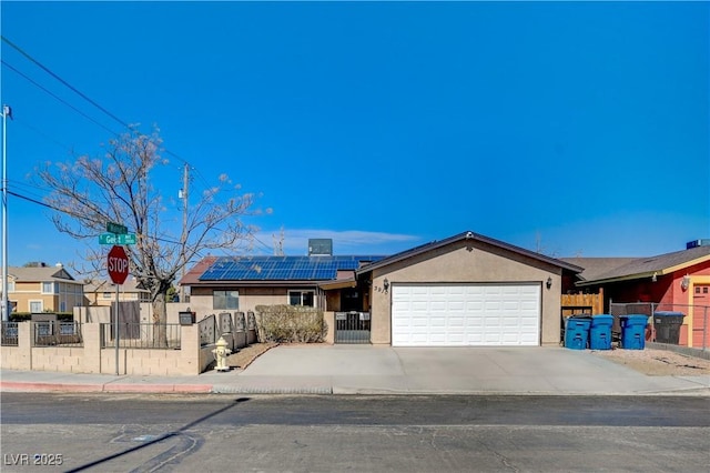 single story home with a garage and solar panels