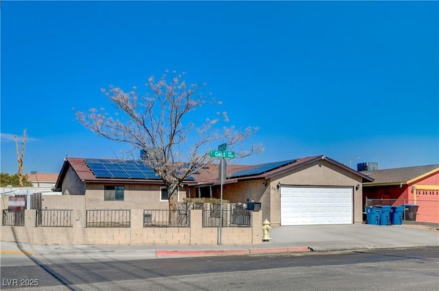 single story home with a garage and solar panels