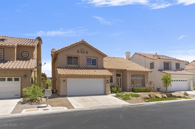 mediterranean / spanish house with a garage