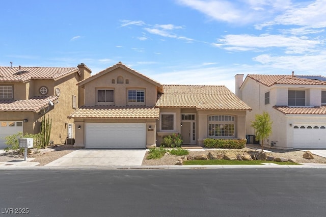 mediterranean / spanish-style home with a garage