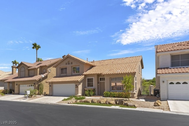 mediterranean / spanish home with a garage