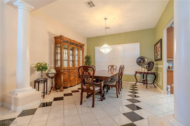 tiled dining room featuring an inviting chandelier and ornate columns