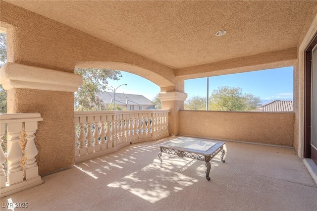 view of patio featuring a balcony