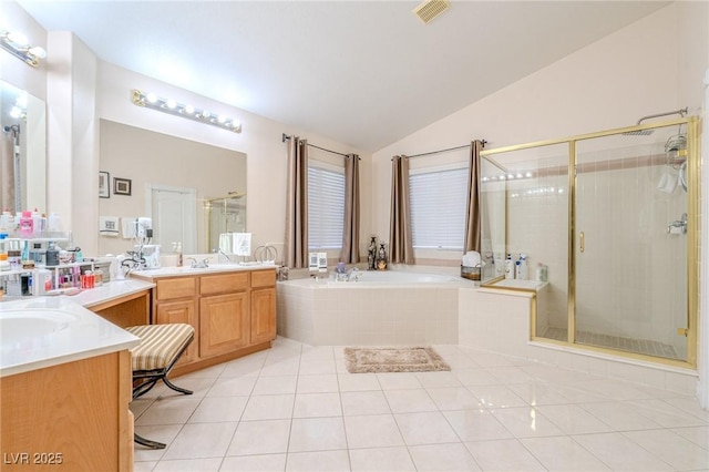 bathroom with tile patterned flooring, vanity, lofted ceiling, and independent shower and bath