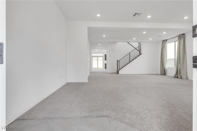 unfurnished living room with light colored carpet