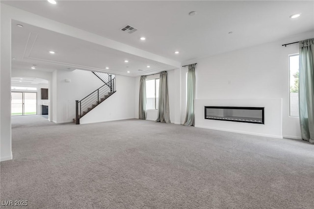 unfurnished living room featuring light colored carpet