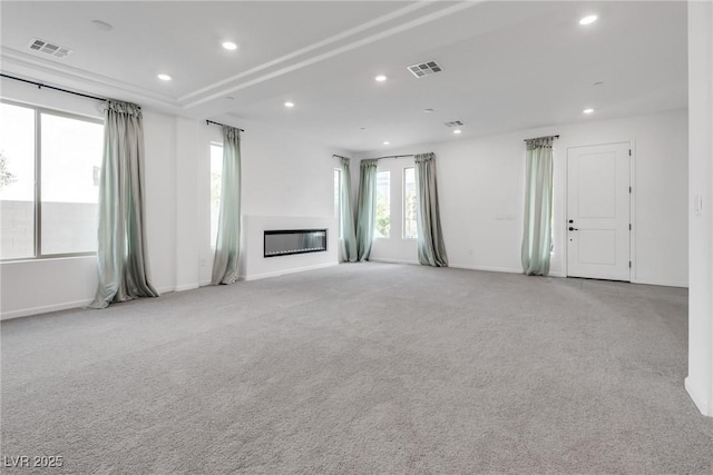 unfurnished living room featuring light carpet