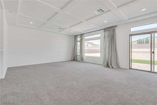 empty room with coffered ceiling, beamed ceiling, and carpet