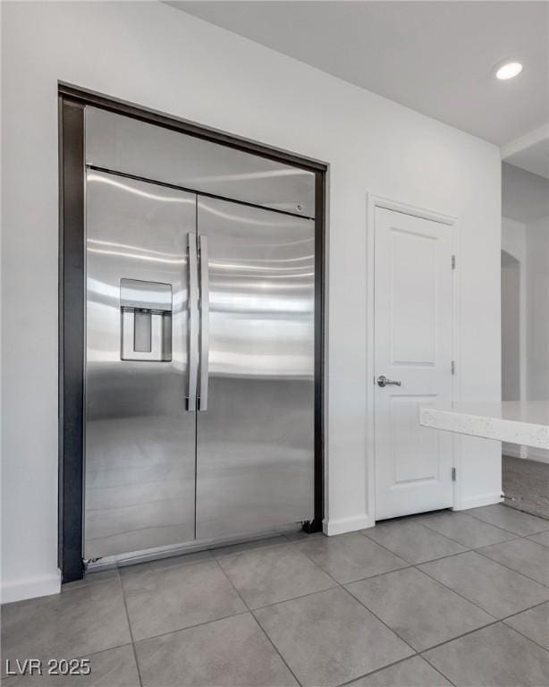 kitchen featuring light tile patterned floors and stainless steel built in refrigerator