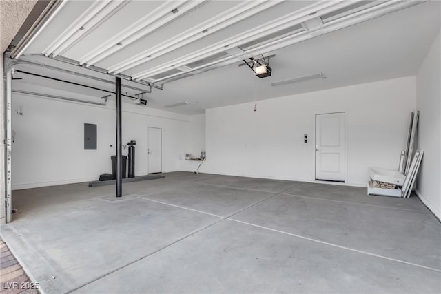 garage with a garage door opener and electric panel