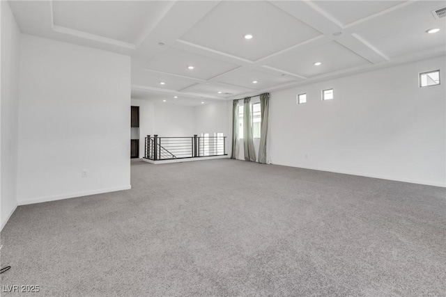 carpeted empty room featuring coffered ceiling and a healthy amount of sunlight