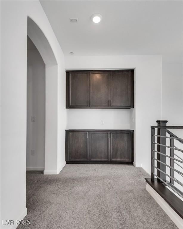 unfurnished living room featuring light colored carpet