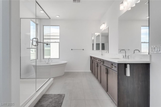 bathroom with vanity and separate shower and tub