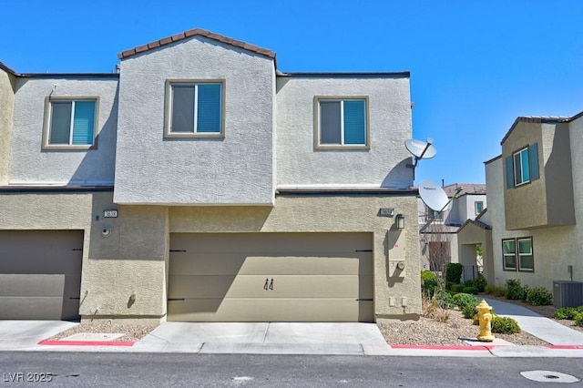 townhome / multi-family property featuring a garage and central AC