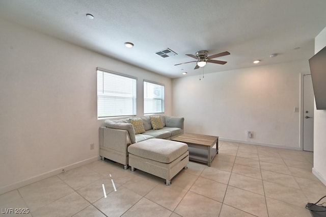 tiled living room featuring ceiling fan