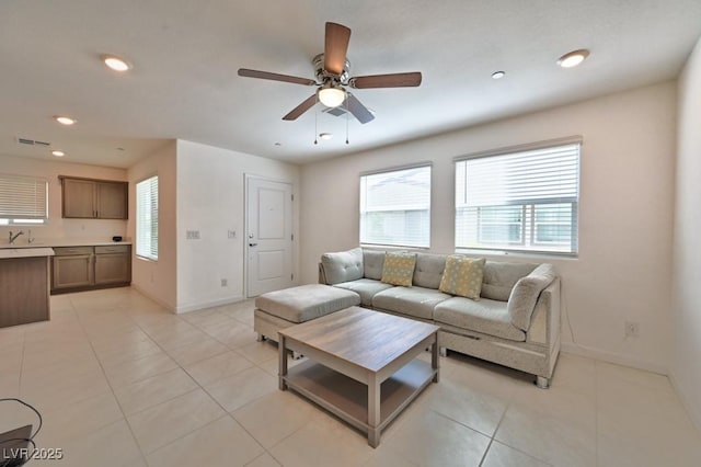 tiled living room featuring sink and ceiling fan