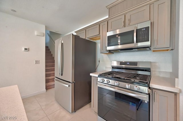 kitchen with appliances with stainless steel finishes and light tile patterned floors