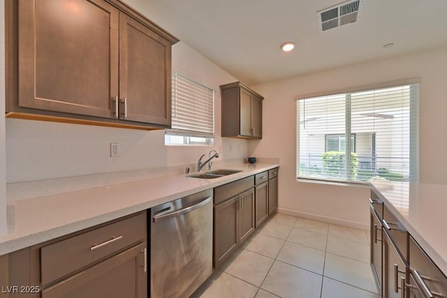 kitchen with sink, light tile patterned floors, plenty of natural light, and dishwasher