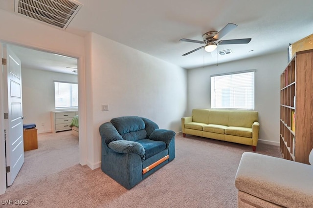 carpeted living room featuring ceiling fan